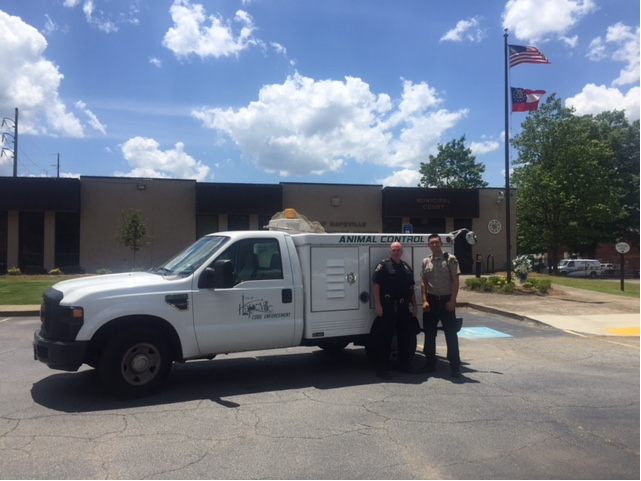 Lieutenant William Hughes and Code Enforcement Officer Zarate with the Animal Control Truck